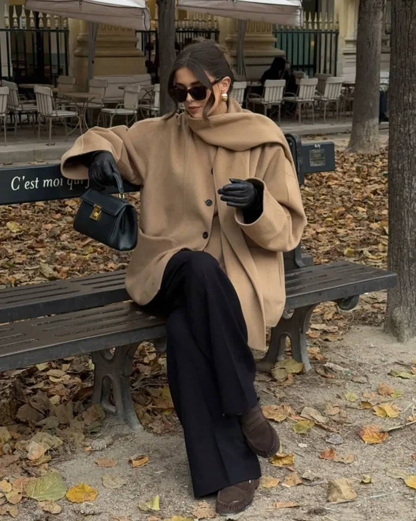 Oatmeal cardigan layered under a camel wool coat with scarf for a cold day