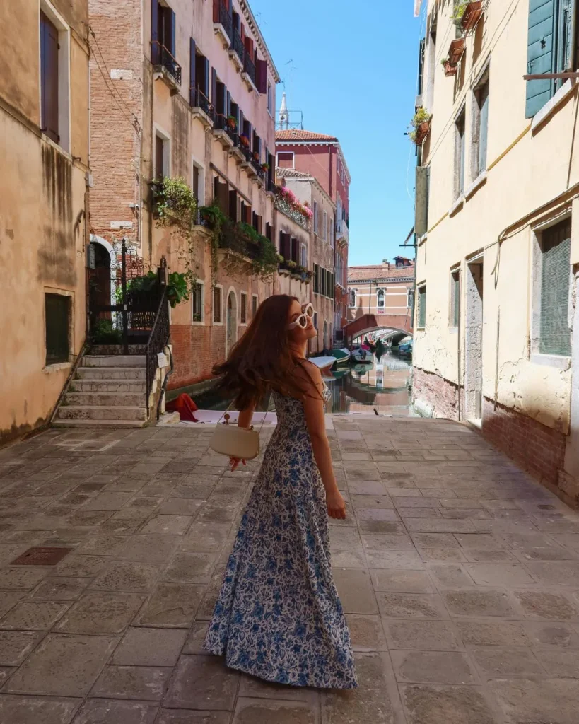 woman sundress cobblestone street Europe